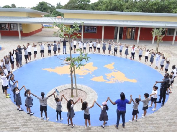 Two students at AKA Dhaka focused on painting and colouring artwork during art class.